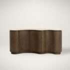 Curved wood sideboard with fluted doors and a light stone top in a warm modern design.