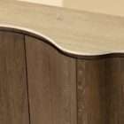 Curved wood sideboard with fluted doors and a light stone top in a warm modern design.