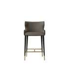 Modern counter stool with taupe upholstered seat, black quilted back detail, and black metal legs with brass accents.