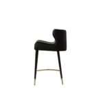 Modern counter stool with taupe upholstered seat, black quilted back detail, and black metal legs with brass accents.