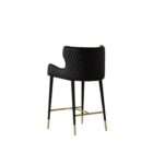 Modern counter stool with taupe upholstered seat, black quilted back detail, and black metal legs with brass accents.
