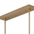 Modern linear chandelier with brass frame and multiple candle-style lights arranged in a sculptural wave pattern.