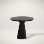 Round black side table with a sculptural pedestal base and minimalist design.