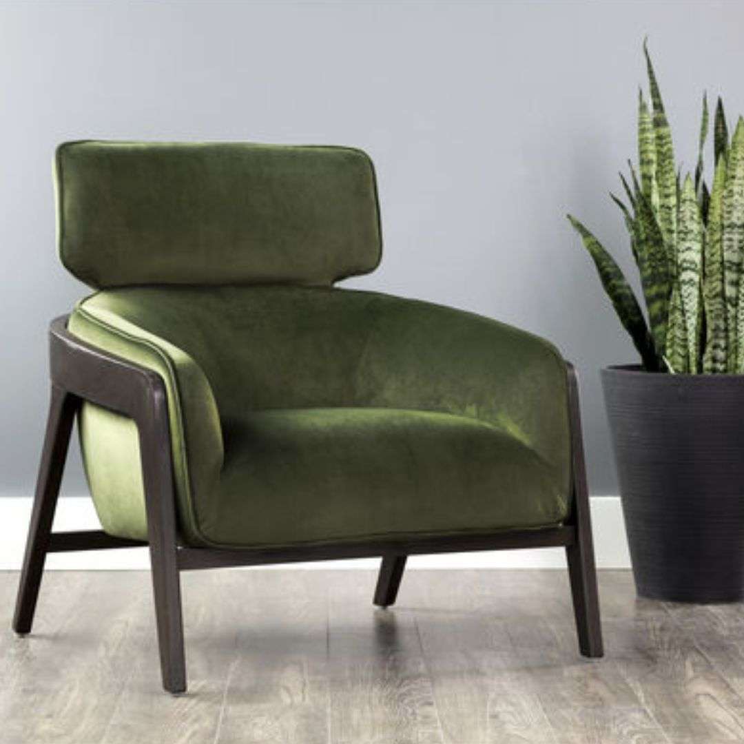 masculine lounge chair that combines modern design elements with contemporary finishes. Stocked in moss green and metropolis blue fabric or with contrasting polo club stone fabric and overcast grey faux leather. A sculpted exposed brown wood frame completes the look.