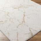 Light ivory area rug with soft gold veining resembling a marble-inspired pattern.