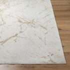 Light ivory area rug with soft gold veining resembling a marble-inspired pattern.