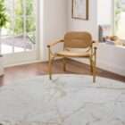 Light ivory area rug with soft gold veining resembling a marble-inspired pattern.