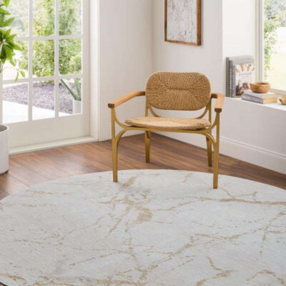 Light ivory area rug with soft gold veining resembling a marble-inspired pattern.