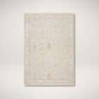 Light neutral area rug with a subtle vintage-inspired pattern in soft beige and ivory tones.
