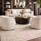 Light neutral area rug with a subtle vintage-inspired pattern in soft beige and ivory tones.