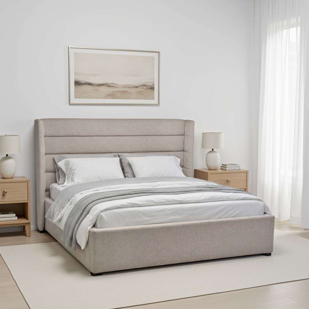 Upholstered bed with a tall channel-tufted headboard, soft neutral fabric, and a low-profile frame.