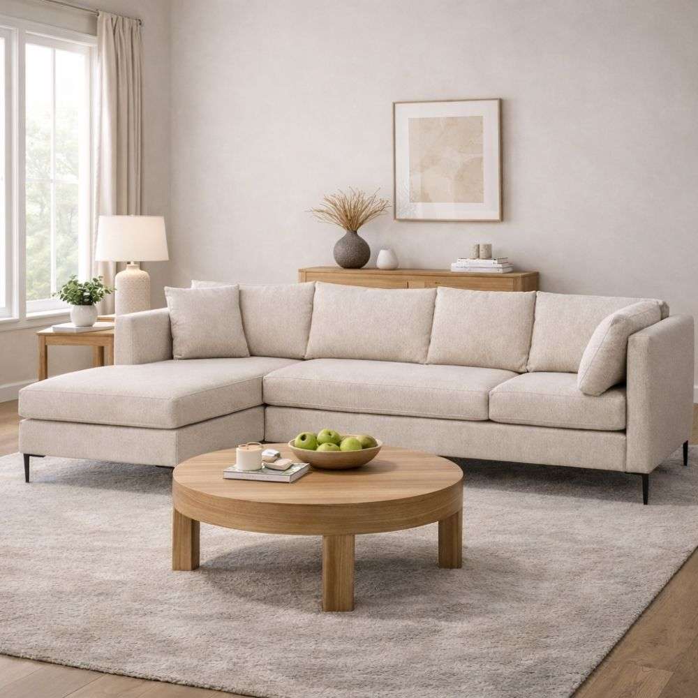 Grey upholstered sectional sofa with chaise, clean lines, plush cushions, and slim black metal legs.