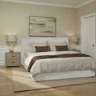 Fully upholstered bed with a clean-lined headboard, soft neutral fabric, and a low-profile frame.