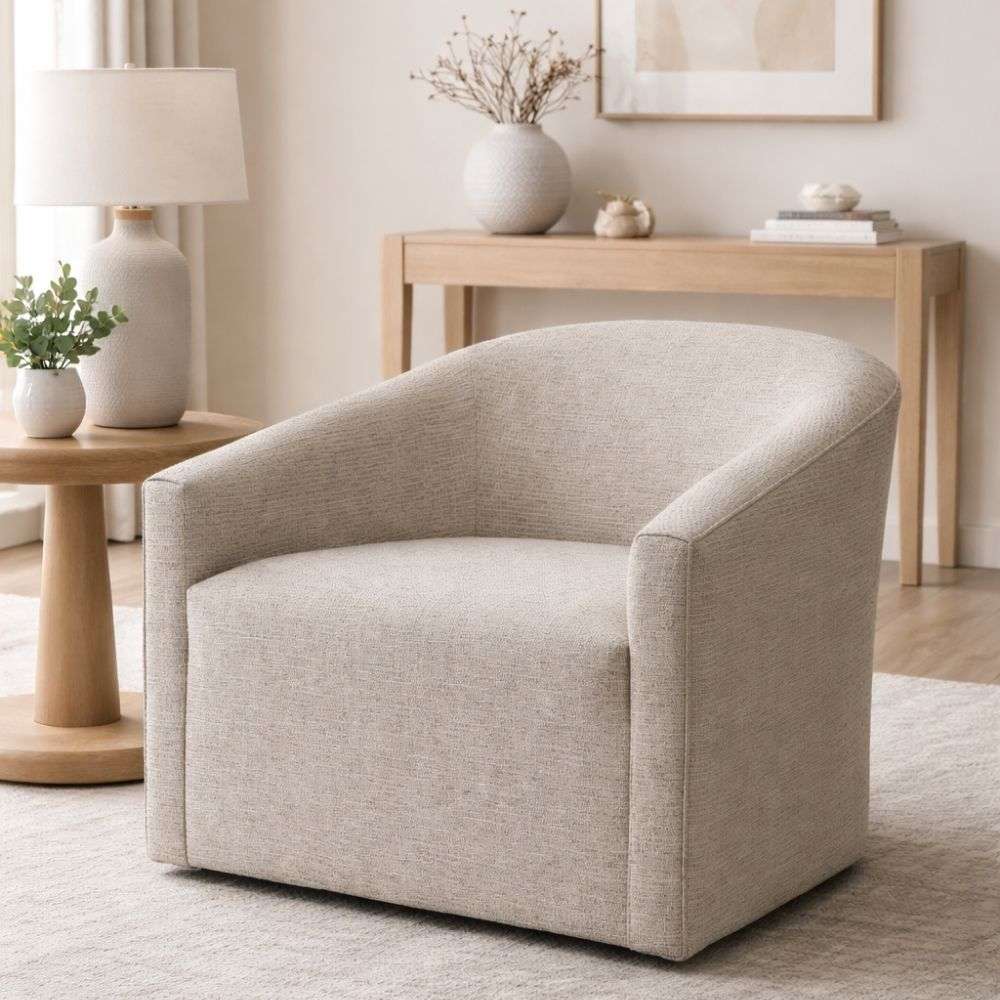 Curved upholstered accent chair in light grey fabric with a low-profile silhouette and rounded back.