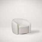 Curved swivel accent chair in soft ivory textured upholstery with a rounded back and compact seat.