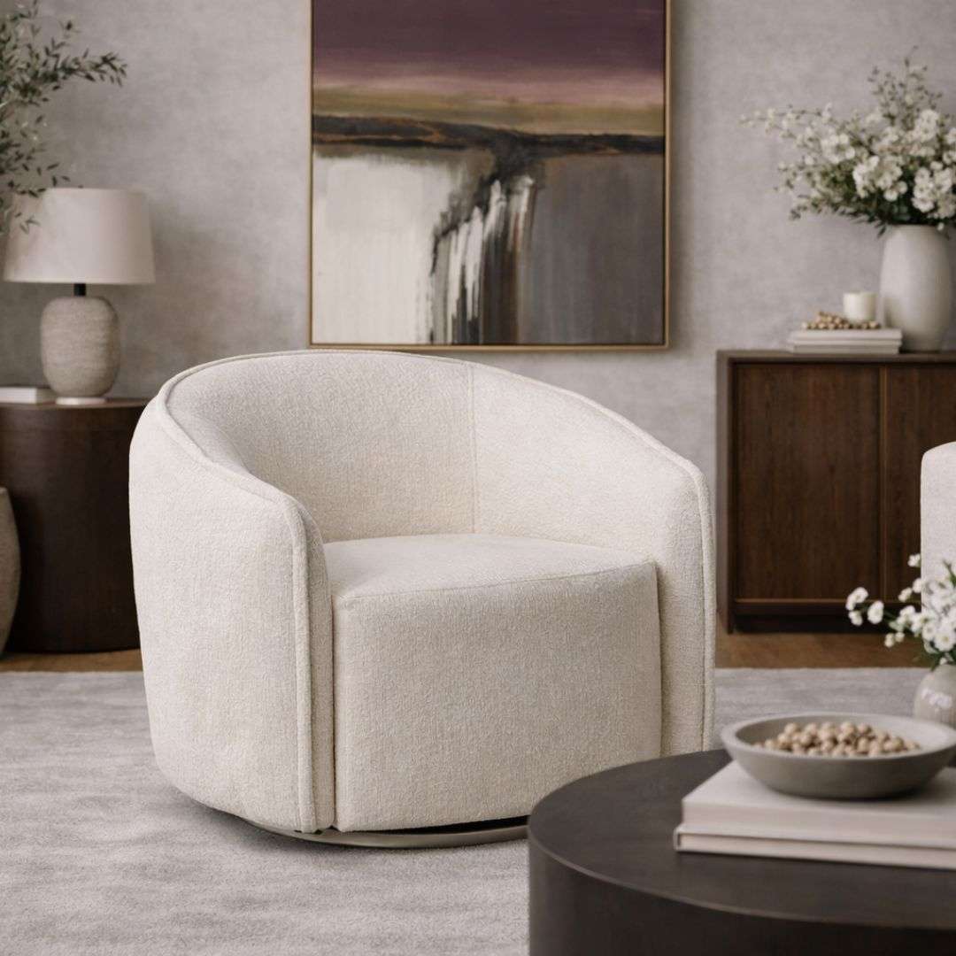 Curved swivel accent chair in soft ivory textured upholstery with a rounded back and compact seat.
