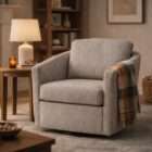 Upholstered swivel accent chair in soft grey fabric with curved arms and a loose back cushion.