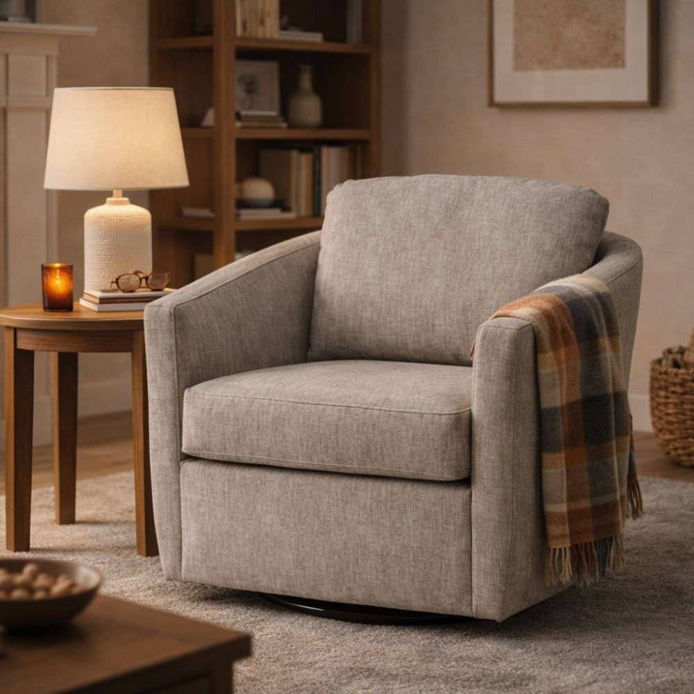 Upholstered swivel accent chair in soft grey fabric with curved arms and a loose back cushion.