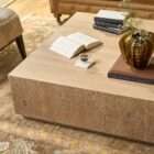 Low-profile square wood coffee table with a minimalist block design in a light natural finish.