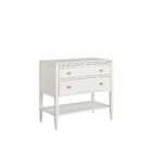 White nightstand with two drawers, slim legs, brass-accented hardware, and an open lower shelf.
