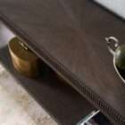 Long wooden console table with a lower shelf, curved legs, and detailed edge trim in a warm medium wood finish.