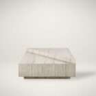 Rectangular travertine coffee table with layered geometric slabs and a natural stone finish featuring subtle linear veining.