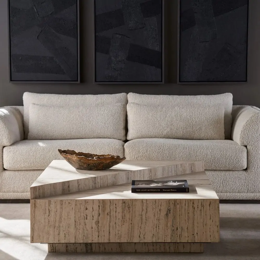 Rectangular travertine coffee table with layered geometric slabs and a natural stone finish featuring subtle linear veining.