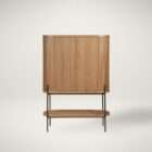 Rounded wood bar cabinet with vertical fluted detailing, black metal legs, and an open lower shelf.