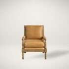 Leather accent chair with a warm tan cushion and back, featuring a solid wood frame with turned spindle detailing on the arms and legs.