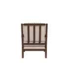 Upholstered accent chair with a natural linen cushion and back, featuring a dark wood frame with turned spindle detailing on the arms and legs.