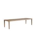 Long rectangular wood dining table with a slim profile, natural finish, and tapered legs.