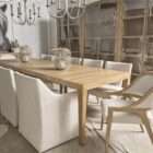 Long rectangular wood dining table with a slim profile, natural finish, and tapered legs.
