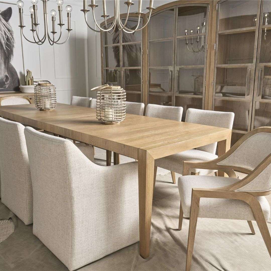 Long rectangular wood dining table with a slim profile, natural finish, and tapered legs.