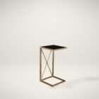 Uttermost Zafina accent table with antique brass metal frame, black glass top, and geometric cross base