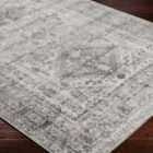Monte Carlo area rug featuring a distressed traditional pattern in soft grey and ivory tones