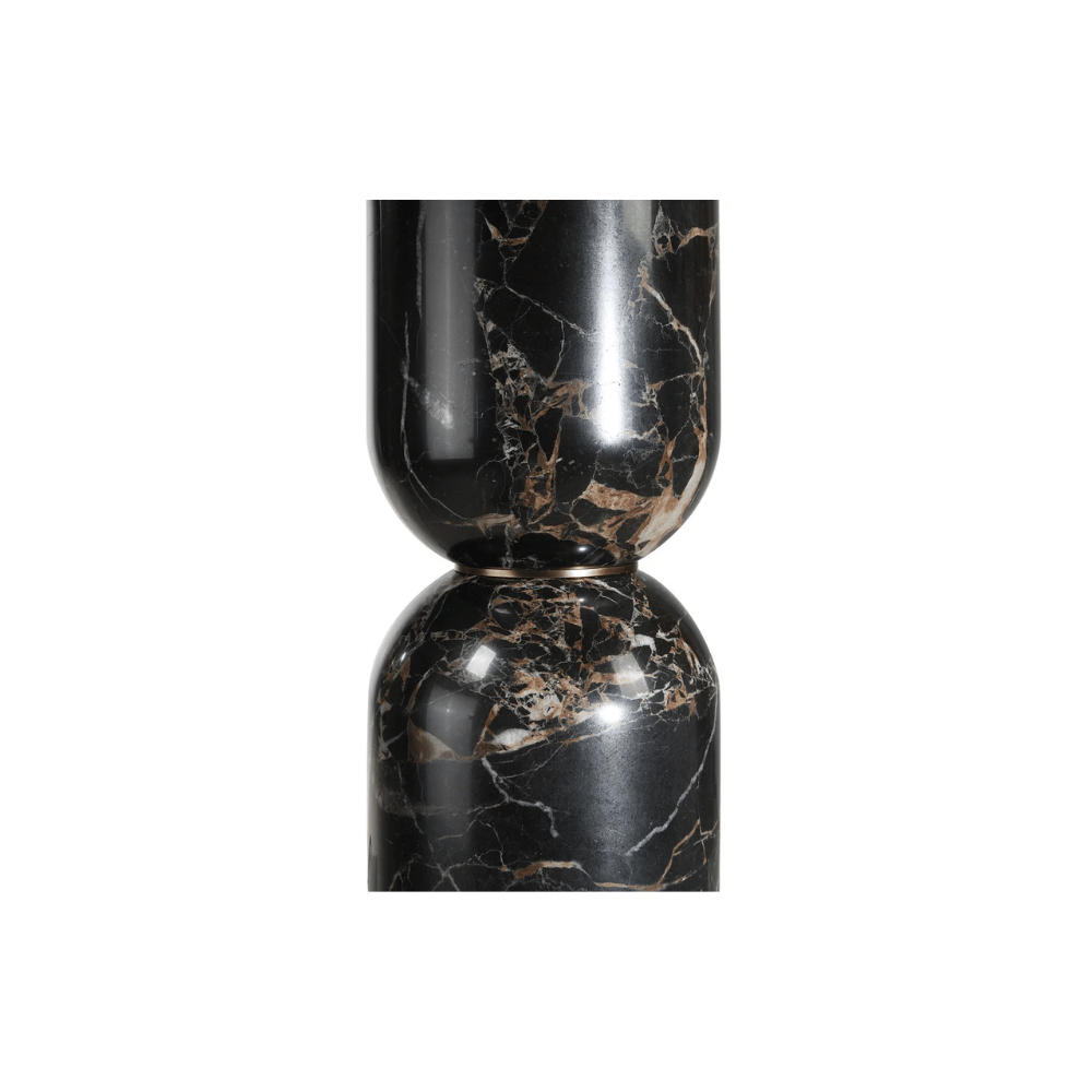 Close-up of a sculptural black marble table lamp base with warm brown and white veining.
