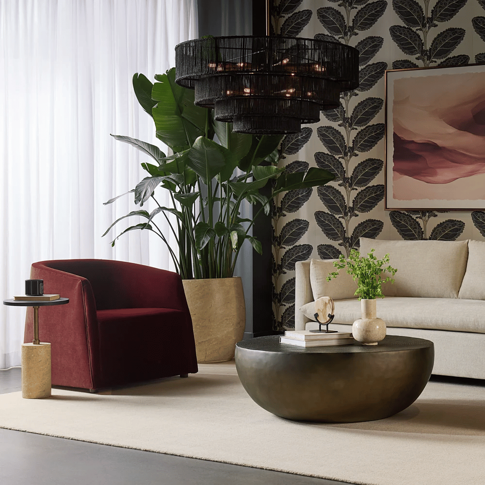 Burgundy Serenade Lounge Chair styled beside a modern side table and oversized indoor plant.